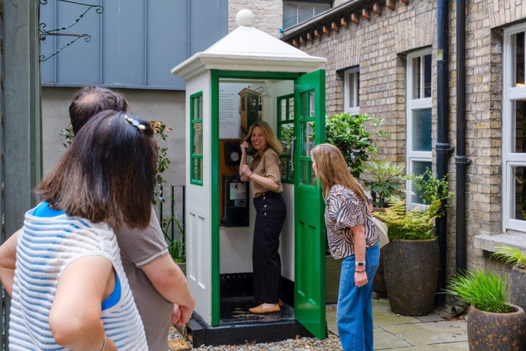 Some guests making calls on the K1 telephone kiosk, Dublin's oldest working phonebox in the back garden of the Little Museum