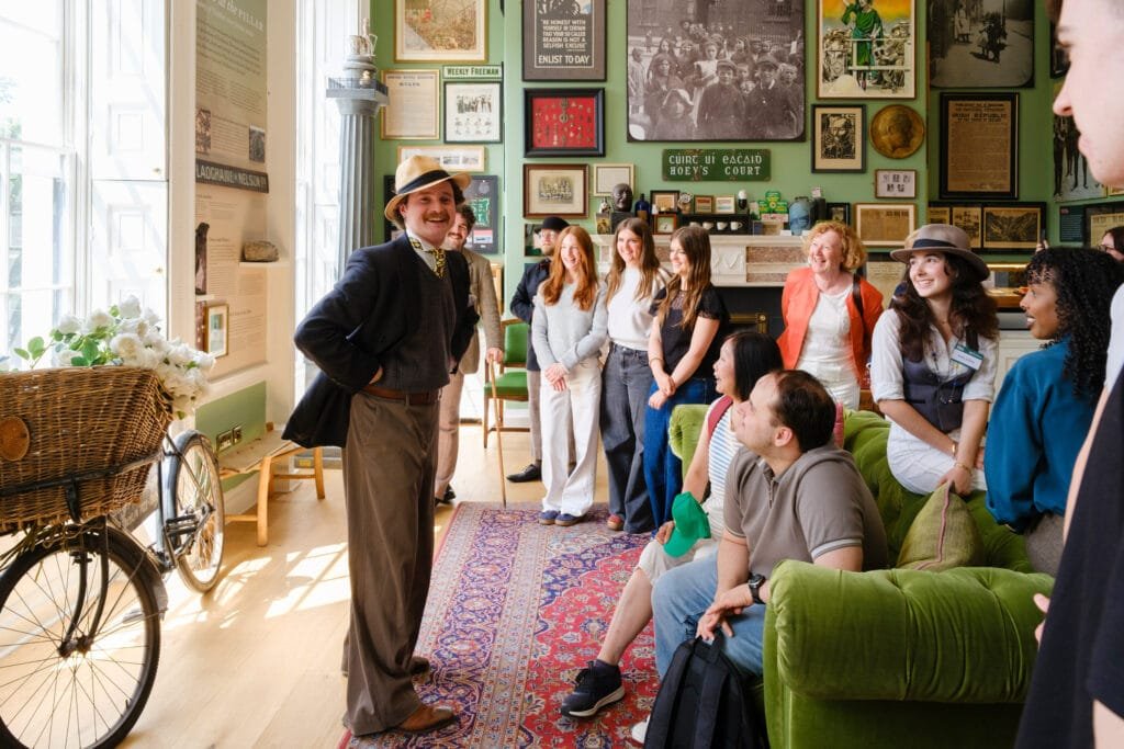 Guests laughing with a tour guide in the 1916 Room of the Little Museum