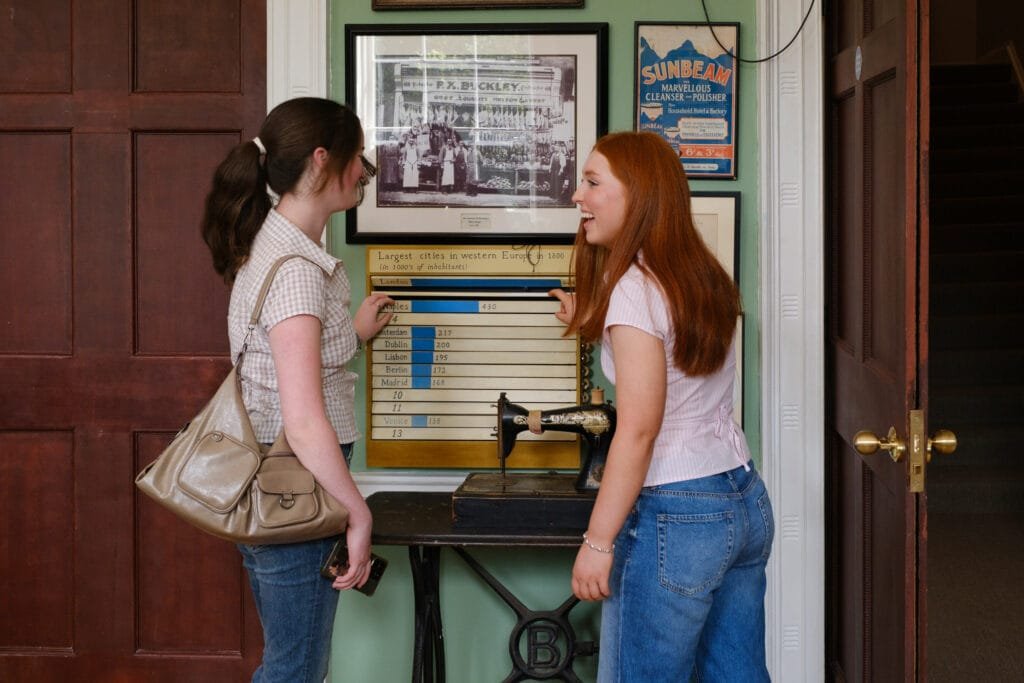 Two guests inspect some artefacts in the 1916 Room of the Little Museum