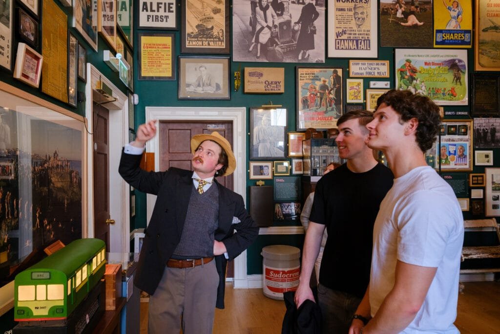 A tour guide points out some interesting artefacts on the wall on the Treasury in the Little Museum