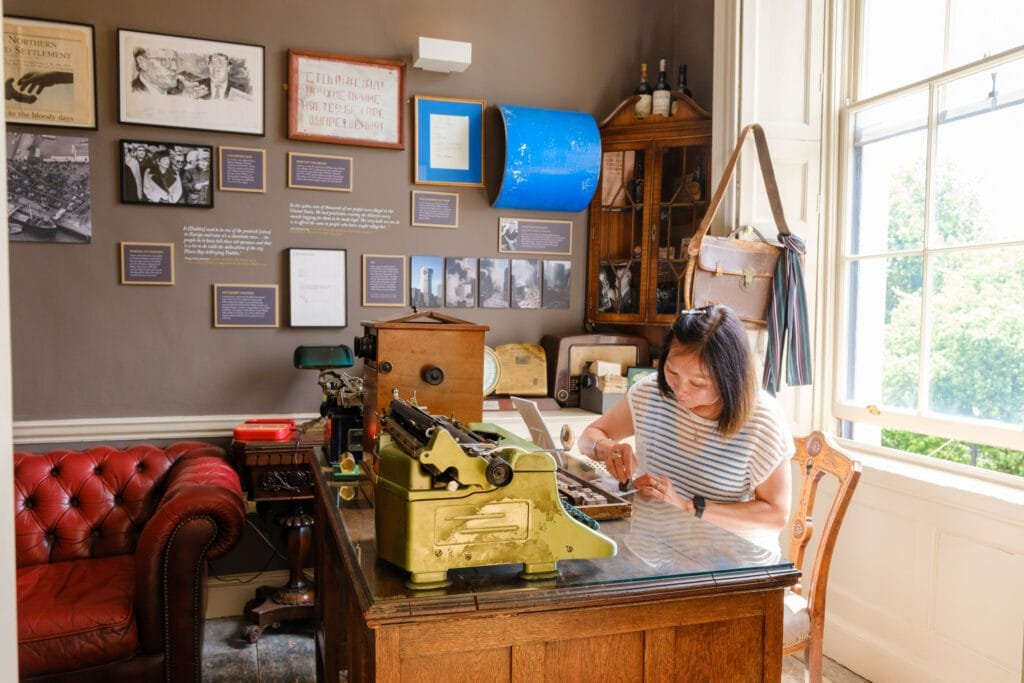 A guest creates their own headline at Bertie Smylie's desk in the Irish Times Room in the Little Museum.