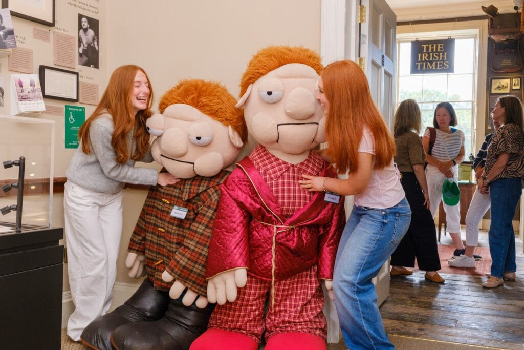 Two young guests meet the museum's oversized versions of Podge and Rodge.