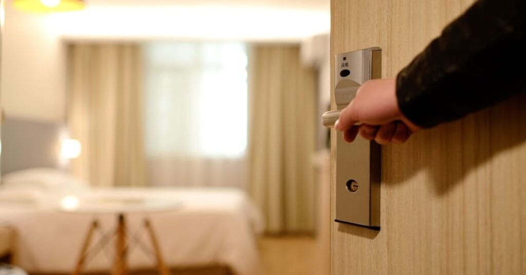A soft-lit hotel room entrance, welcoming guests with luxury appeal and comfort.