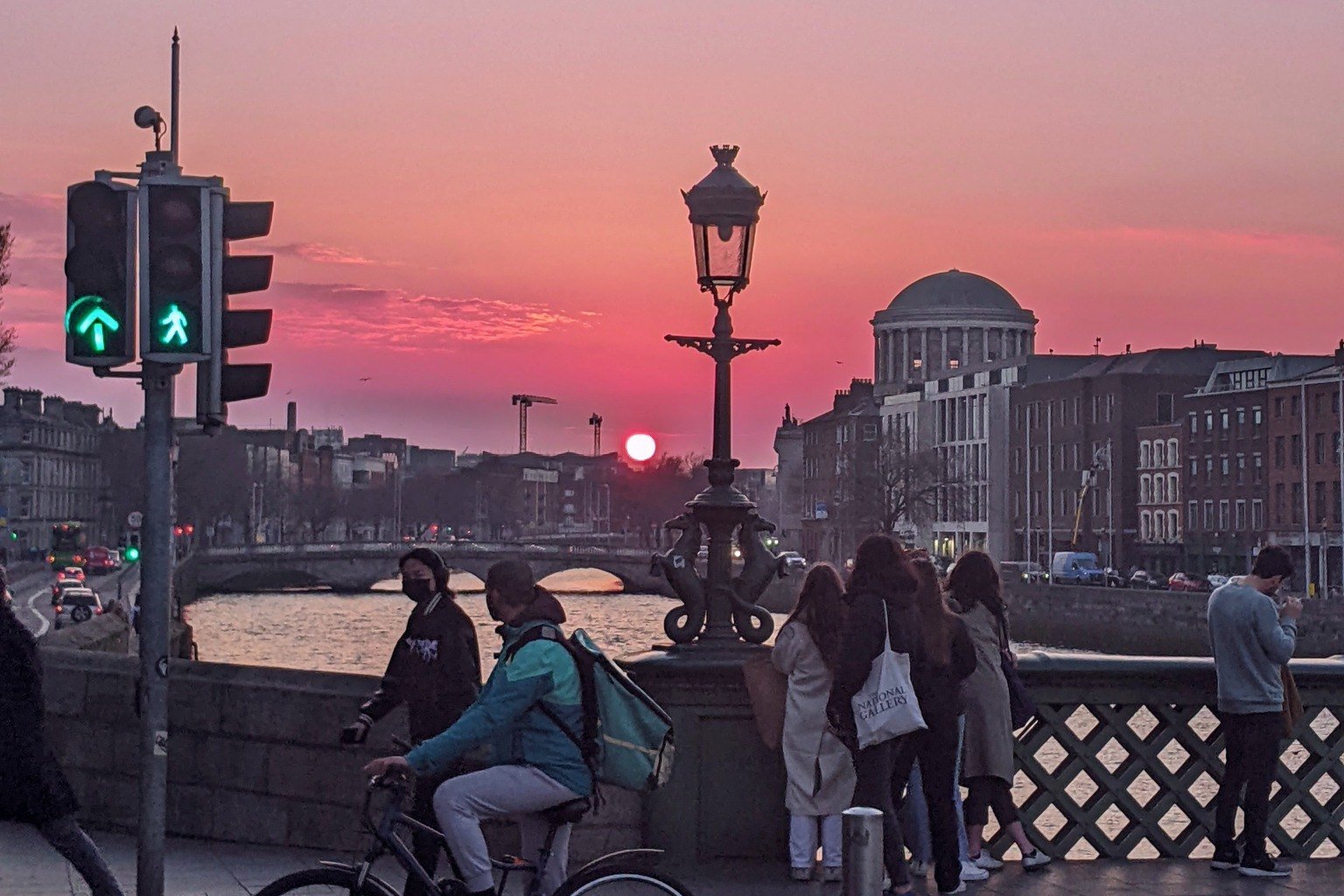 Sunset over the River Liffey from Grattan Bridge in Dublin, with the Four Courts dome at dusk